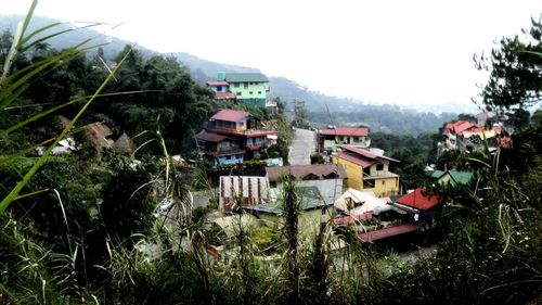 Houses in village against sky