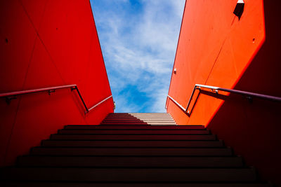 Low angle view of empty steps against blue sky