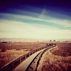 Scenic view of field against cloudy sky