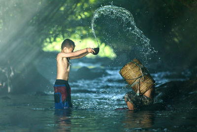 Boy standing by river