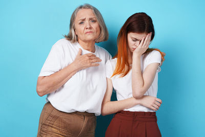 Friends standing against blue background