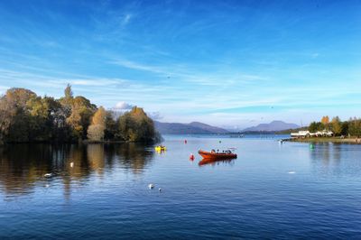 Scenic view of calm lake against mountain range