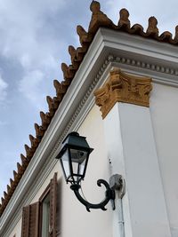 Low angle view of sculpture on building against sky