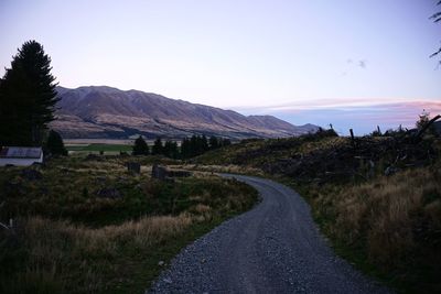 Road amidst field against sky