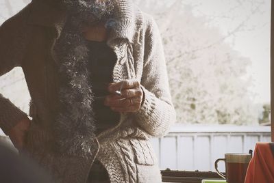 Close-up of woman standing against wall
