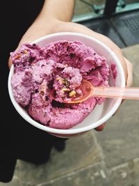 High angle view of woman holding ice cream in bowl