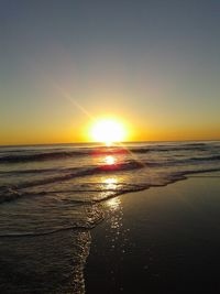 Scenic view of beach against sky during sunset