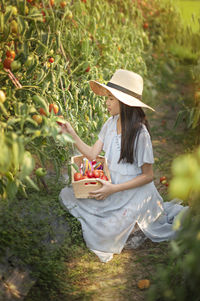 Woman holding ice cream by plants