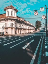 Road by building against sky