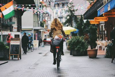 Rear view of woman walking on street