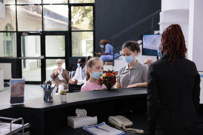 Rear view of business colleagues working in office