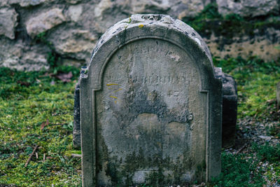 Close-up of stone cross in cemetery