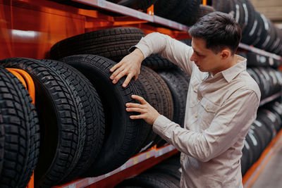 Man choosing tire at store