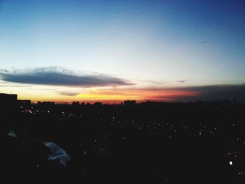 Silhouette cityscape against sky during sunset