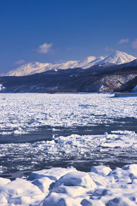 Scenic view of snowcapped mountains against sky