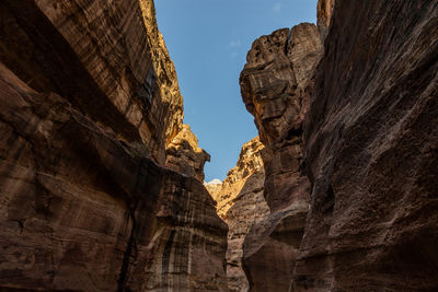 Low angle view of rock formations against sky