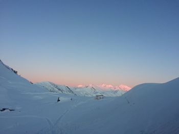 Scenic view of snowcapped mountains against clear blue sky