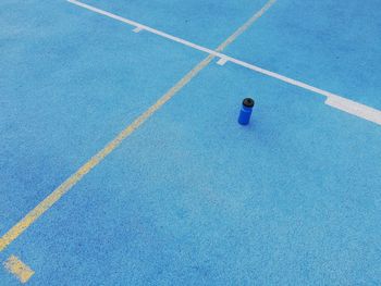 High angle view of blue water bottle running tracks