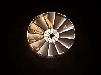 Close-up of illuminated electric lamp against black background