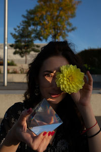 Portrait of woman holding flower