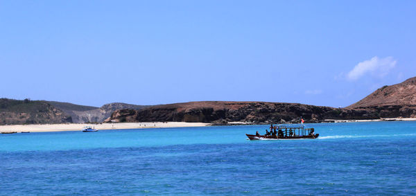 Scenic view of sea against clear blue sky