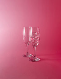Champagne glasses with transparent balls. abstract minimal light pink composition.