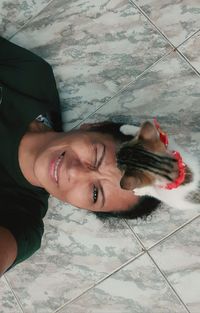 High angle portrait of young woman on floor