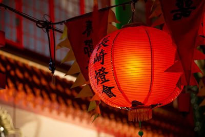 Low angle view of illuminated lanterns hanging in park