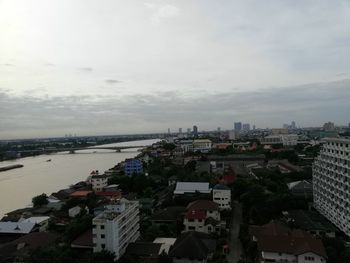 High angle view of buildings and sea against sky