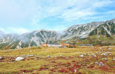 Scenic view of mountains against cloudy sky