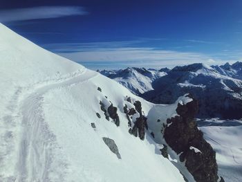 Scenic view of snow covered mountains against sky