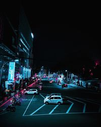 Cars on city street at night