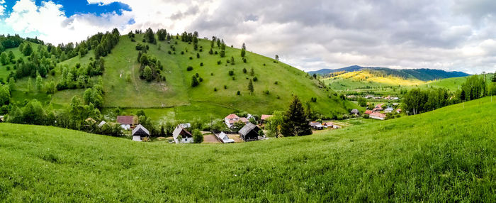 View of houses on landscape against sky