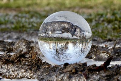 Close-up of crystal ball on rock