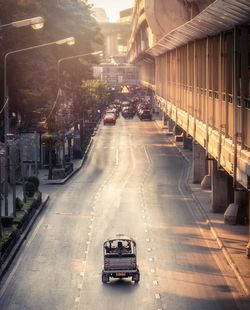 High angle view of vehicles on road along buildings