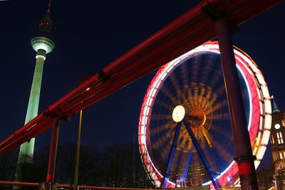 Low angle view of illuminated ferris wheel at night