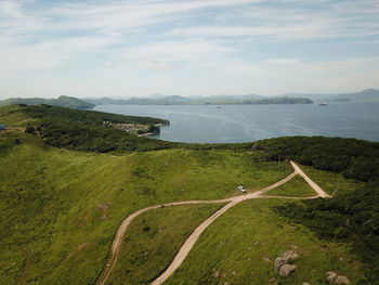 High angle view of road by land against sky