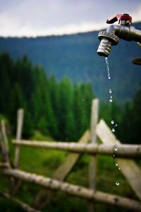 Low angle view of water coming from faucet