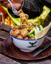 Close-up of person preparing food on table