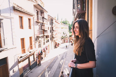 Woman standing by railing