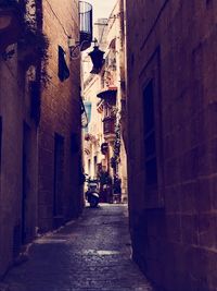 Narrow alley amidst buildings in town