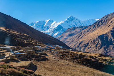 Scenic view of mountains against clear blue sky