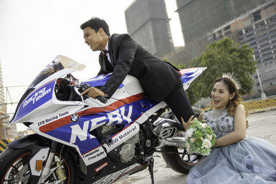 Young couple sitting on road in city