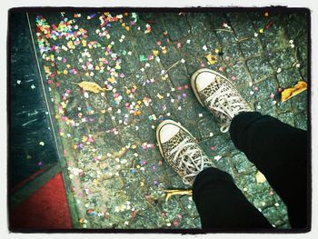 Low section of woman standing on tiled floor