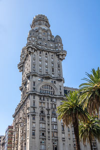 Low angle view of building against clear blue sky