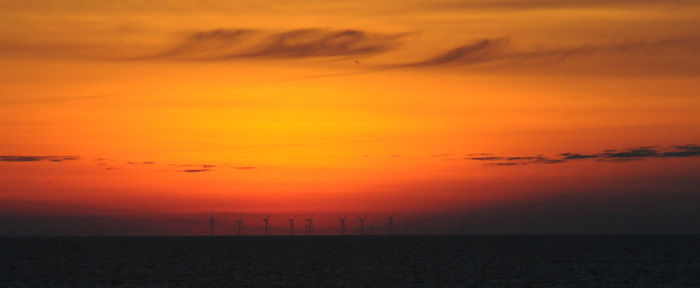 Scenic view of sea against romantic sky at sunset