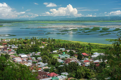 Limboto lake with a clear sky and houses in the foreground