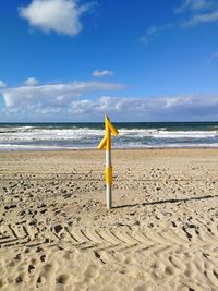 Lifeguard hut on beach against sky