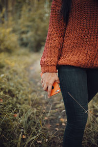 Midsection of woman standing on field