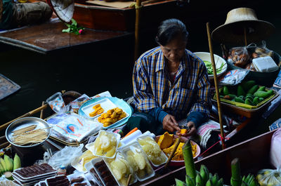 People sitting at market stall